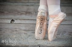 a ballerina's feet in ballet shoes with the number 2013 written on them