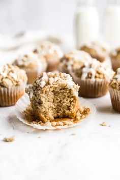 cupcakes with white frosting and crumbs sitting on top of each other