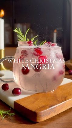 a white christmas sangria with cranberries and rosemary