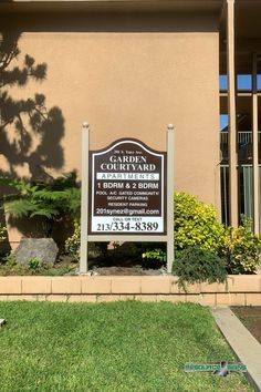 a sign in front of a building that says garden courtyard on the side of it