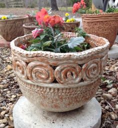 some very pretty pots with flowers in them