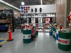 the inside of a car repair shop filled with lots of products and tools on display