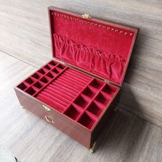 an open wooden box with many compartments