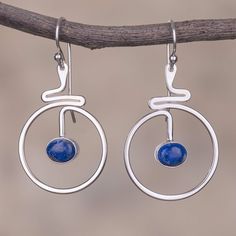 Two swirling moons are carefully handcrafted of high-polish sterling silver wire dangling from the ears with an ethereal elegance. Peruvian artisan Tiberio Gonzales designs this pair of dangle earrings choosing ovals of natural blue lapis lazuli that hang within the open lunar circles. Lapis Lazuli Earrings, Lapis Ring, Sterling Silver Dangle Earrings, Blue Lapis, Jewelry Business, Silver Earrings Dangle, Elegant Earrings, Minimalist Earrings, Hook Earrings