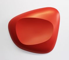 a red object on a white surface with no one in it's place to see the image