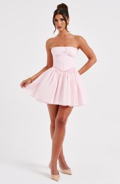 This mini is having a moment! Made in a premium cotton blend fabric, this strapless design features a boned corset to snatch the waist and a super full skirt. The look is complete with delicate lace trims and shirring to the back. 



Colour: Blush.

Premium non-stretch cotton blend fabric.

Fully lined.

Strapless with lace trim.

Gathered, underwired cups.

Boning in corset.

Lace trim detail.

Super full skirt.

Shirred back detail.

Mini length.

Model is an XS and is wearing an XS.

 Size: Corset Dress Short, Short Corset Dress, Homecoming Dresses Corset, 23 Birthday, Corset Dresses, Prom Inspo, Hoco Dress, Maxi Dress Sale, Corset Mini Dress