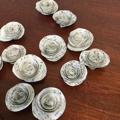 several pieces of music paper are arranged on a wooden table with sheet music notes in the middle