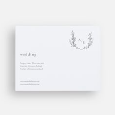 the front and back of a wedding card with a floral wreath on it's side