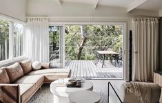 a living room filled with furniture and a sliding glass door that leads to a deck