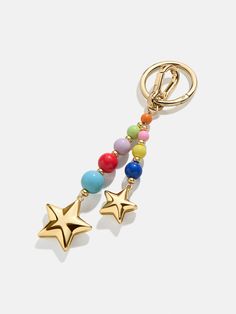 a gold keychain with beads and stars on it