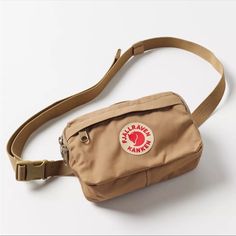 Urban Outfitters Fjallraven Kanken Belt Bag-The Knken Pack By Fjllrven Offers Convenient Storage In A Compact Design, Made From The New Vinylon F - A Synthetic Hard-Wearing Fabric That Resists Withstands Moisture. Main Compartment Is Complemented By A Security Pocket Against The Body, An Inner Slip Pocket And A Webbing Buckle Strap. Content + Care -100% Vinylon F (Polyvinyl Alcohol) - Spot Clean - Imported Size - Length: 3.54" -Width: 7" - Height: 4.72" Fjallraven The First To Commercially Make Casual Everyday Bags From Urban Outfitters, Mochila Fjallraven Kanken, Vintage Canvas Bags, Ultimate Gift Guide, Bags Aesthetic, Half Zip Sweaters, The Ultimate Gift, Kanken Backpack, Fjallraven Kanken