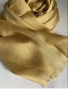 STUNNING LUXURY GOLD SCARF Beautiful delicate soft light weight fringe trim scarf  This scarf is a perfect accessory for both daytime and evening wear  Made from Rayon silk  Gold colour  180cm length x 89cm width (approx)  Note : The colour of the scarf may appear slightly different in person as screen settings and lighting can affect how it looks on the phone or computer. Classic Gold Silk Scarf, Elegant Yellow Dupatta, Formal Gold Silk Scarf, Elegant Beige Festive Scarves, Elegant Beige Scarves For Festive Season, Formal Gold Silk Dupatta, Gold Shawl For Formal Festive Occasions, Formal Festive Gold Shawl, Elegant Gold Scarf For Wedding