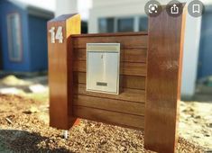 a close up of a mailbox on the side of a building with wood siding