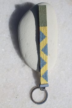 a rock with a keychain attached to it sitting on top of a white surface