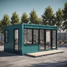 a green shipping container sitting on top of a cement ground