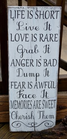 a wooden sign that says life is short, love is rare and anger is bad