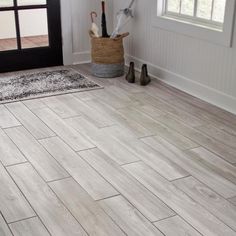 an entryway with wood flooring and white walls