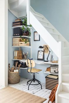 a home office under the stairs with bookshelves