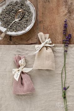 two bags of lavender tea next to each other on a table with spoons in them