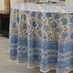 a blue and white table cloth with flowers on it