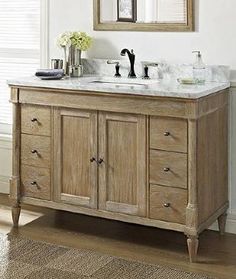 a bathroom vanity with two sinks and mirrors