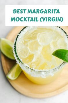 the best margarita mocko cocktail recipe with limes and ice on a wooden platter