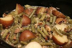 potatoes and green beans are cooked in the crock pot with sauce on top, ready to be eaten