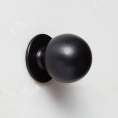 a black door knob on a white wall