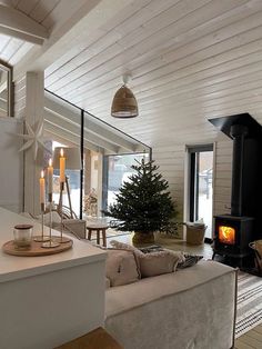 a living room filled with furniture and a fire place next to a wooden burning stove