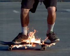 a man riding a skateboard on top of a fire