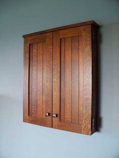 a wooden cabinet hanging on the wall