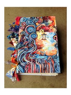 a book with an artistic painting on it