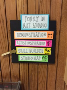 there is a sign on the wall that says today in art studio demonstration artist instruction skill builder studio day