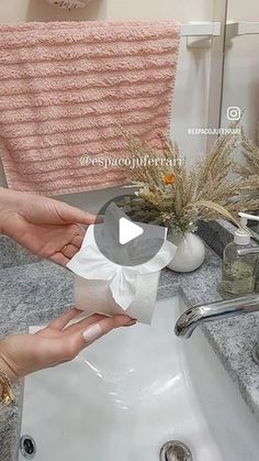 a woman is washing her hands in the bathroom sink