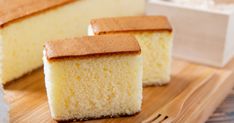 two pieces of cake sitting on top of a wooden cutting board