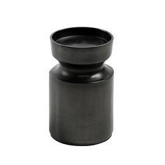 a black vase sitting on top of a white surface