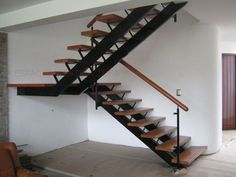 a living room with a couch and a stair case