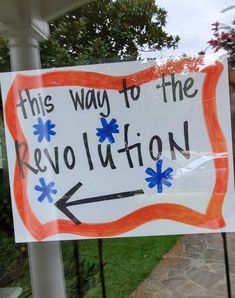 a sign that says this way to the revolution