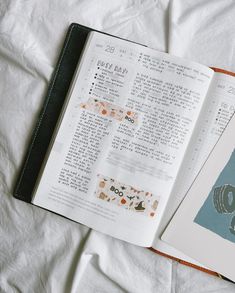 an open book sitting on top of a white sheet