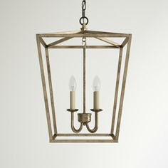 a chandelier with two candles hanging from it's center and one light on the other side