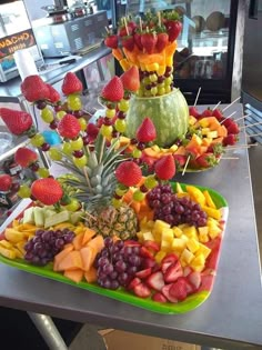 there are many different types of fruits on the trays that have been cut up