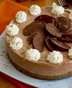 a chocolate cake topped with whipped cream and cookies