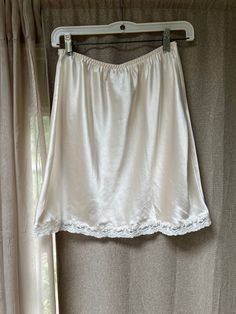 Very pretty Christian Dior short half slip in like new condition.  The size tag is Large but I think it's more like a Medium.   Please check measurements below - 16" length 38" around hips Up to 32" around waist. A little bit of soft lace around the hem.   There were a couple of teeny fuzzy poufs which I was able to 'shave' off with a lint shaver. Wash by hand and hang to dry.  If you iron do so on reverse side. Thrift Manifestation, Lint Shaver, Slip Top, Womens Lingerie, Satin Lingerie, Half Slip, Hip Ups, Ivory Silk, Lace Slip Dress