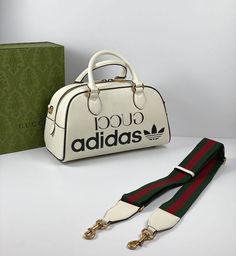 Part of the adidas x Gucci collection, this mini duffle bag features the 'Gucci adidas' and Trefoil print. adidas and Gucci venture into a collection, where the Web juxtaposes with the three white stripes, and the GG monogram combines with the trefoil. Pulling inspiration from the Creative Director’s memories of the '80s and '90s, emblematic House’s motifs mix with those of the historic sportswear brand adidas resulting in a series of hybrid looks.es. Gucci Adidas Bags, Gucci X Adidas Bag, Gucci Adidas Bag, Duffle Bag Aesthetic, Adidas X Gucci, Gucci X Adidas, Adidas Bag, Gg Collection, Gucci Adidas