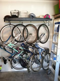 there are many bikes that are on the rack in this garage, and it is very organized