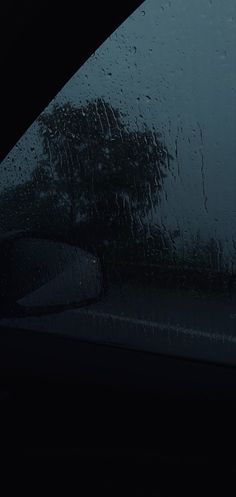 rain is falling on the windshield of a car