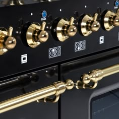 an oven with many knobs and brass handles