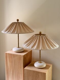 two lamps sitting on top of wooden blocks