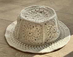 a crocheted hat sitting on top of a wooden floor