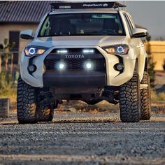 the front end of a white toyota truck